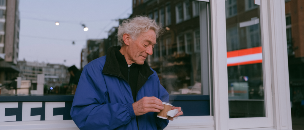 Man drinkt koffie bij lokaal cafe in Amsterdam